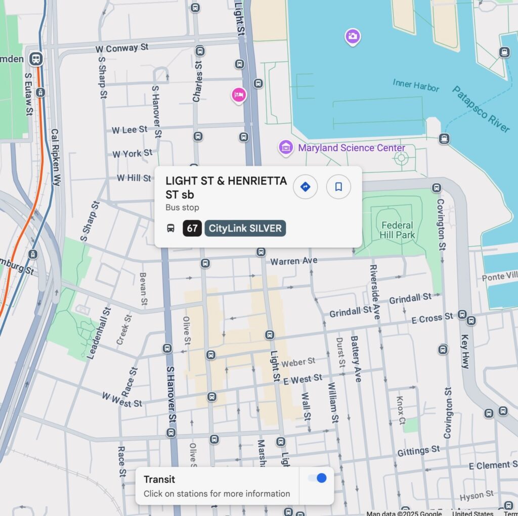 Google Map screenshot of Baltimore's Inner Harbor showing the transit layer. There are a number of bus stops and a few train stops.